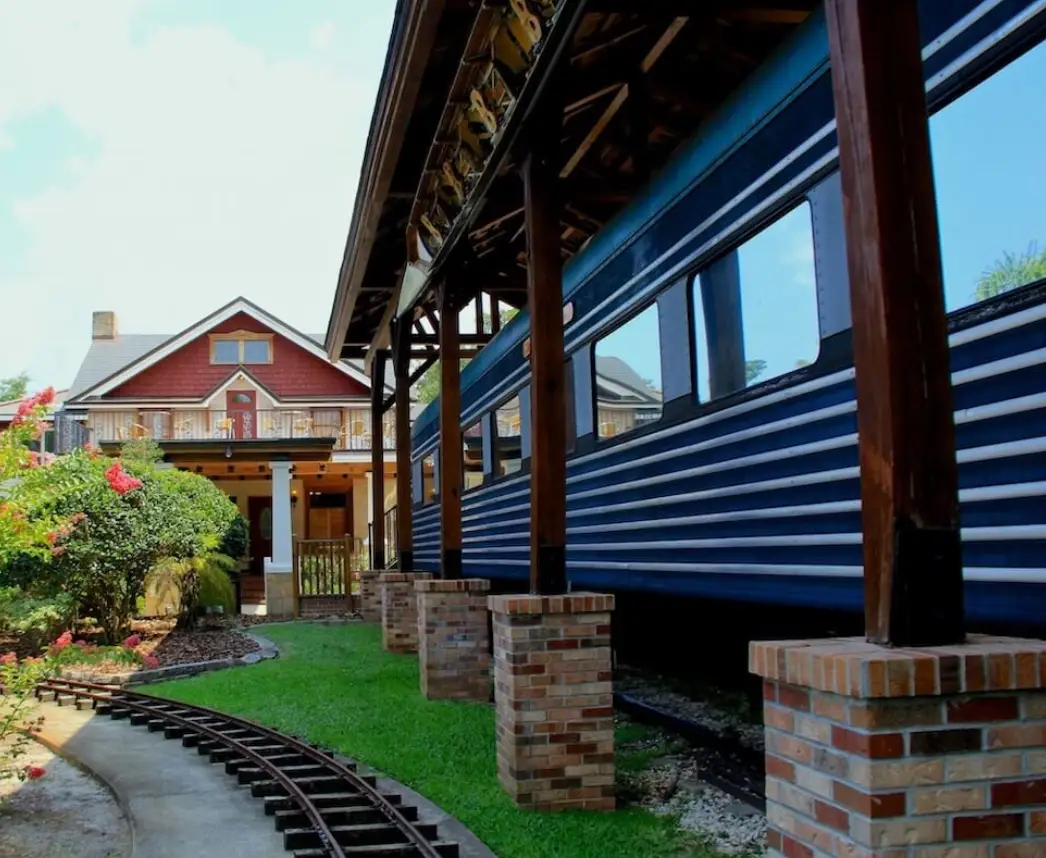 Blue historic Club Car train carriage beneath a covered platform at The Estate on the Halifax