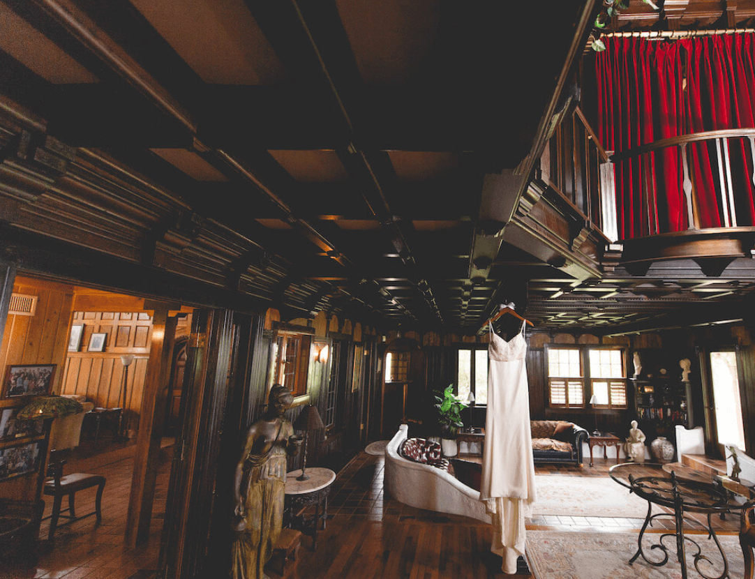 Wedding dress hanging in the wood-paneled sitting room of Agatha’s Guesthouse
