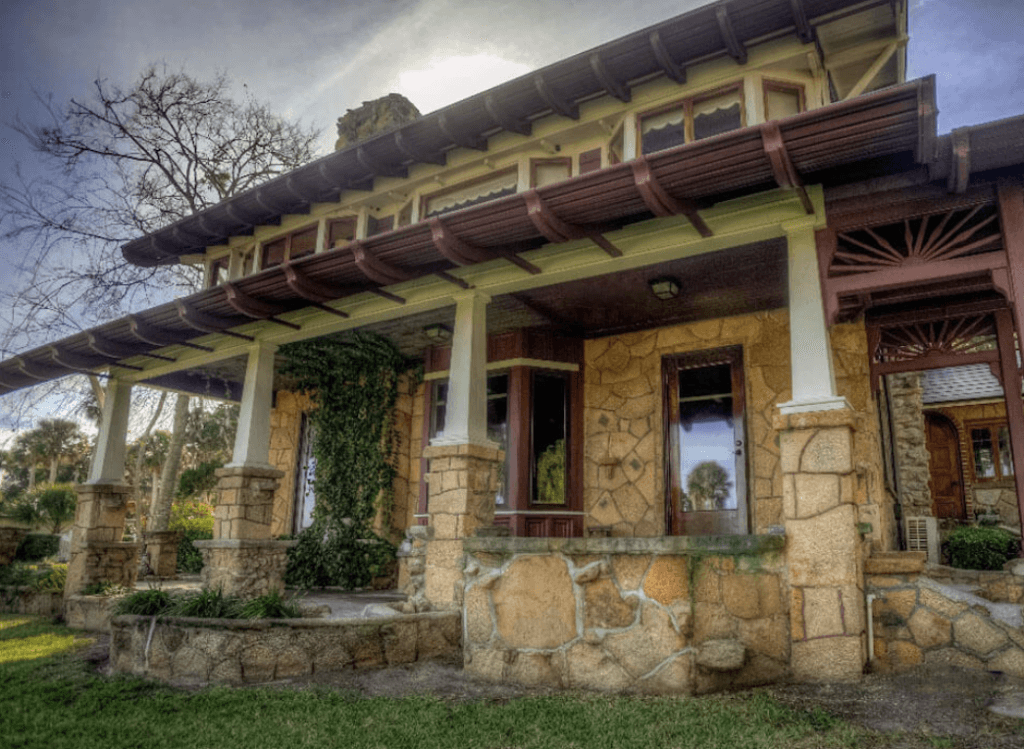 Historic stone facade and covered front porch of Agatha’s Guesthouse